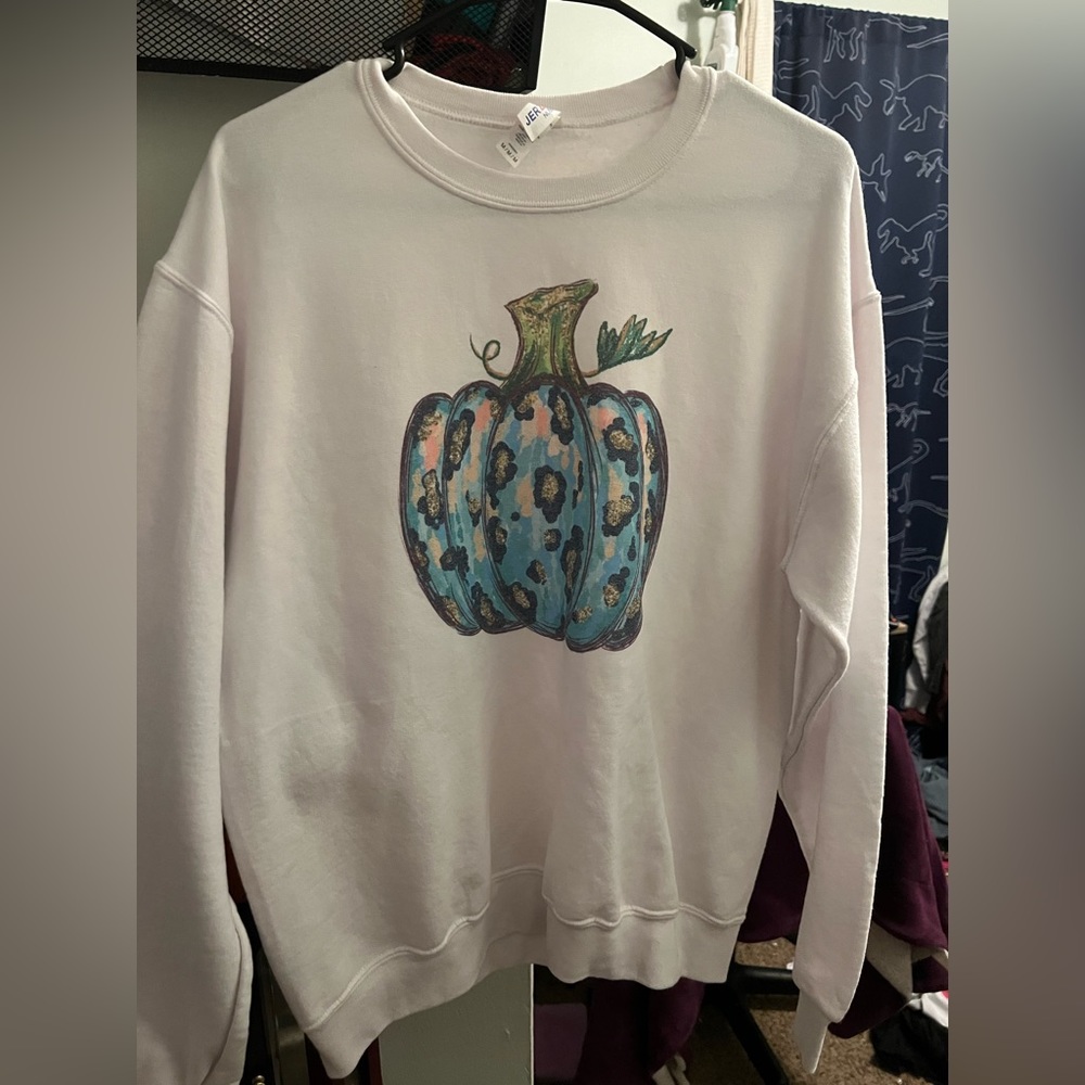 White sweater with a chetah print pumpkin.